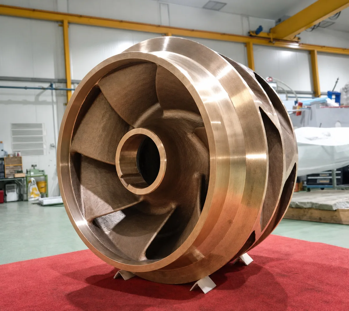 Large bronze-coloured replacement impeller casting after production and partial machining