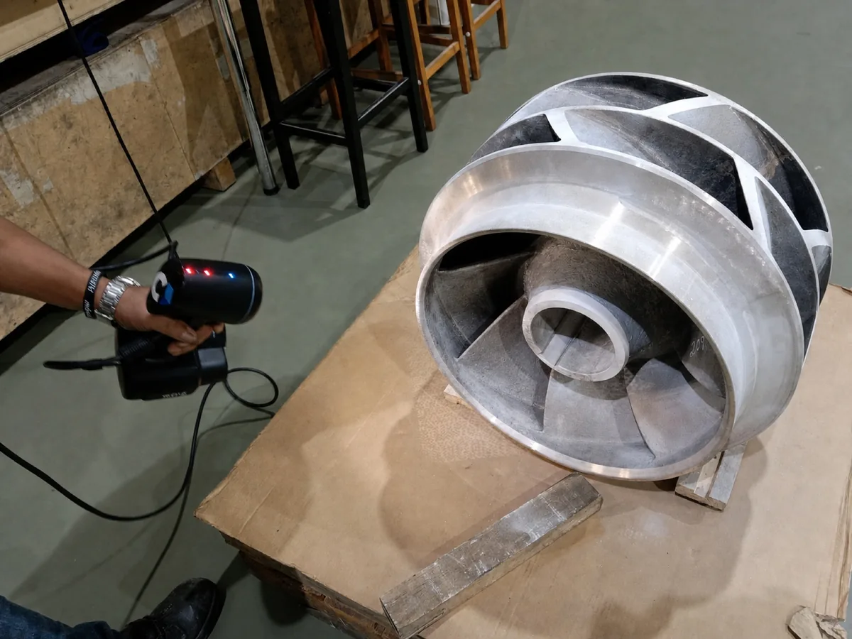 Handheld non-contact scanner being used to capture the geometry of the manufactured impeller
