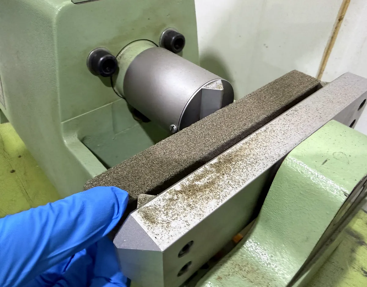 Mold material test specimen positioned in testing equipment during inspection
