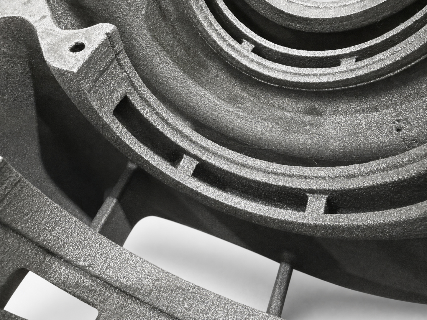 Close-up of curved internal flow passages inside a cast iron pump housing