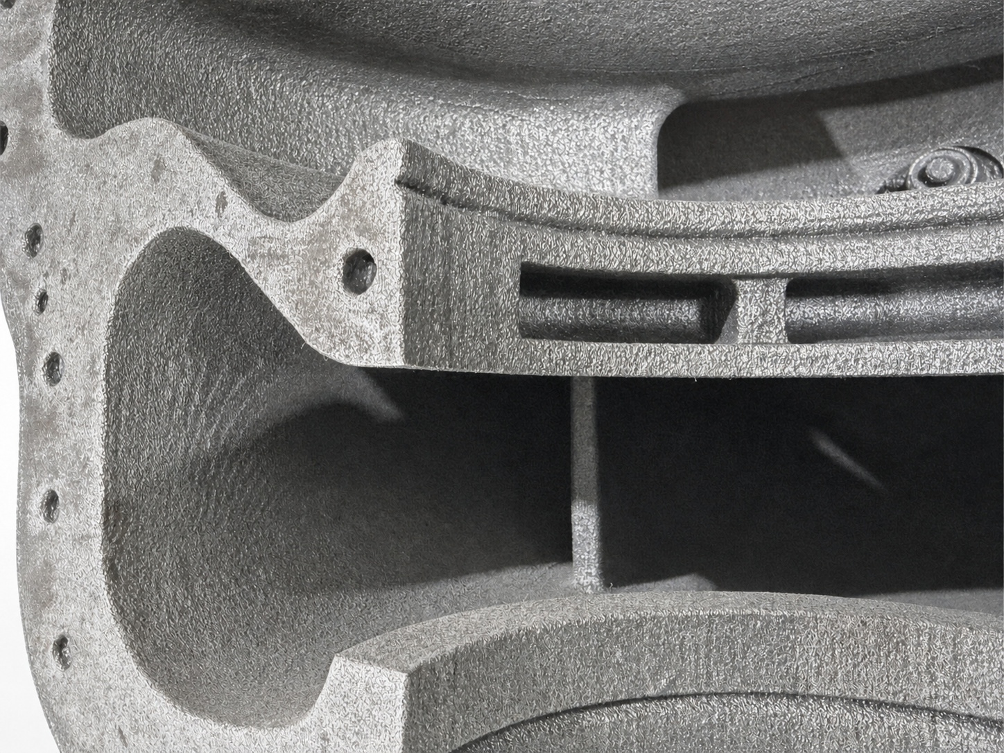 Close-up of internal core geometry inside a cast iron pump housing