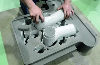 Printed sand cores being placed into the mold before closing