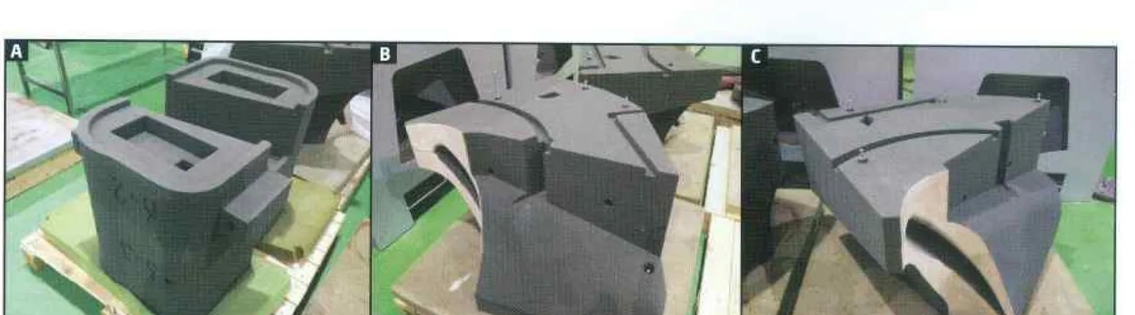 Three printed sand mould parts resting on timber supports before assembly
