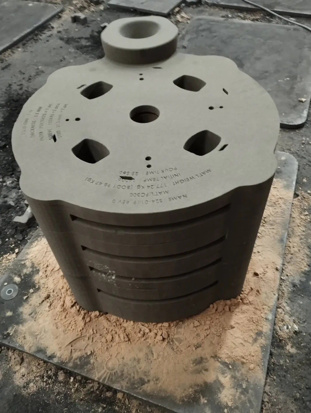 Top view of the printed sand mold showing riser pockets, pouring inlet and printed identification data