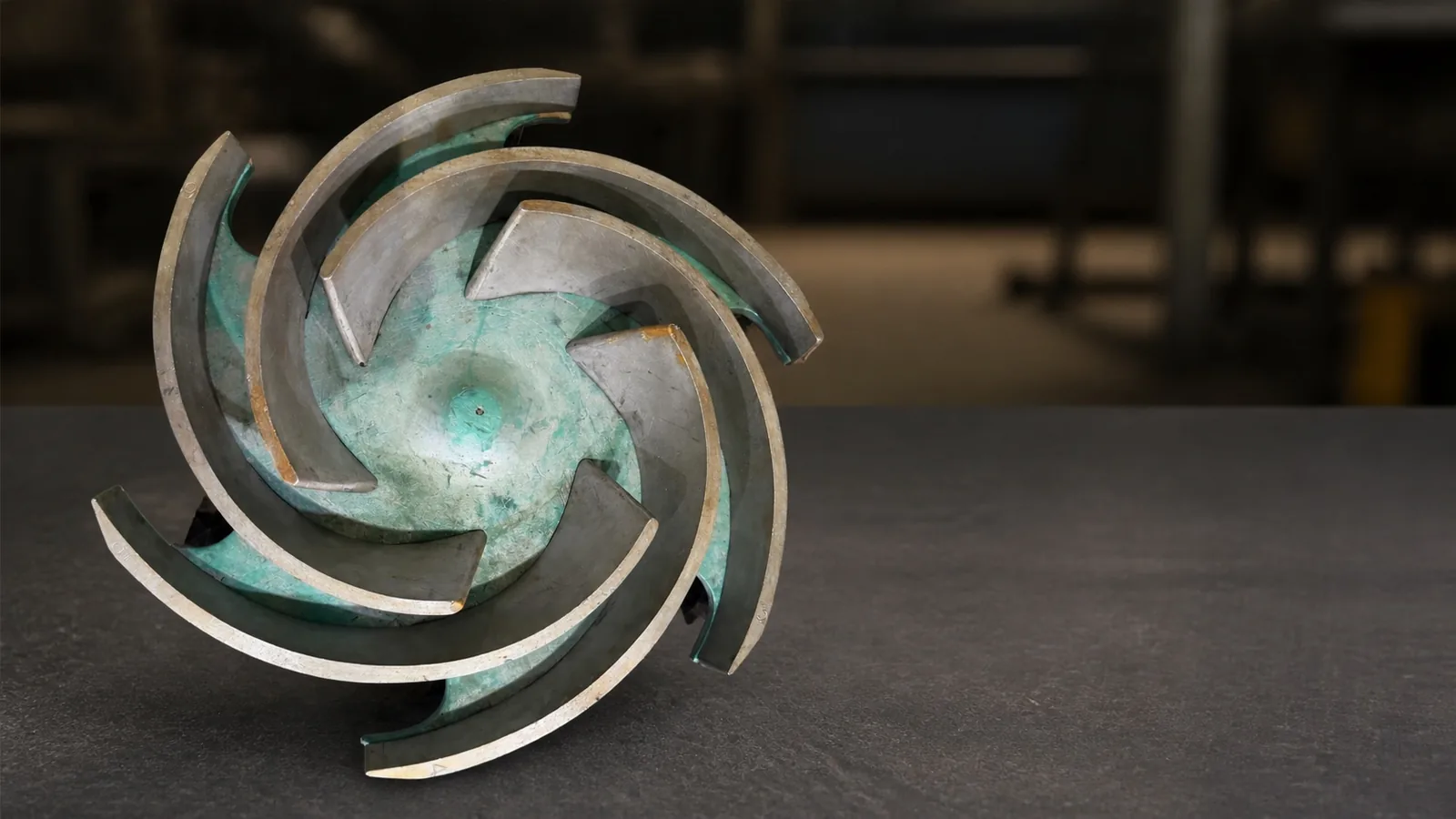 Reusable impeller pattern with curved vanes, viewed from above on a workshop surface