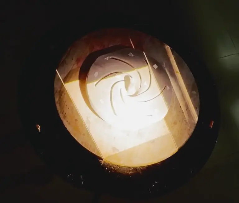 Projected scanning light pattern across a cast impeller during 3D surface data capture