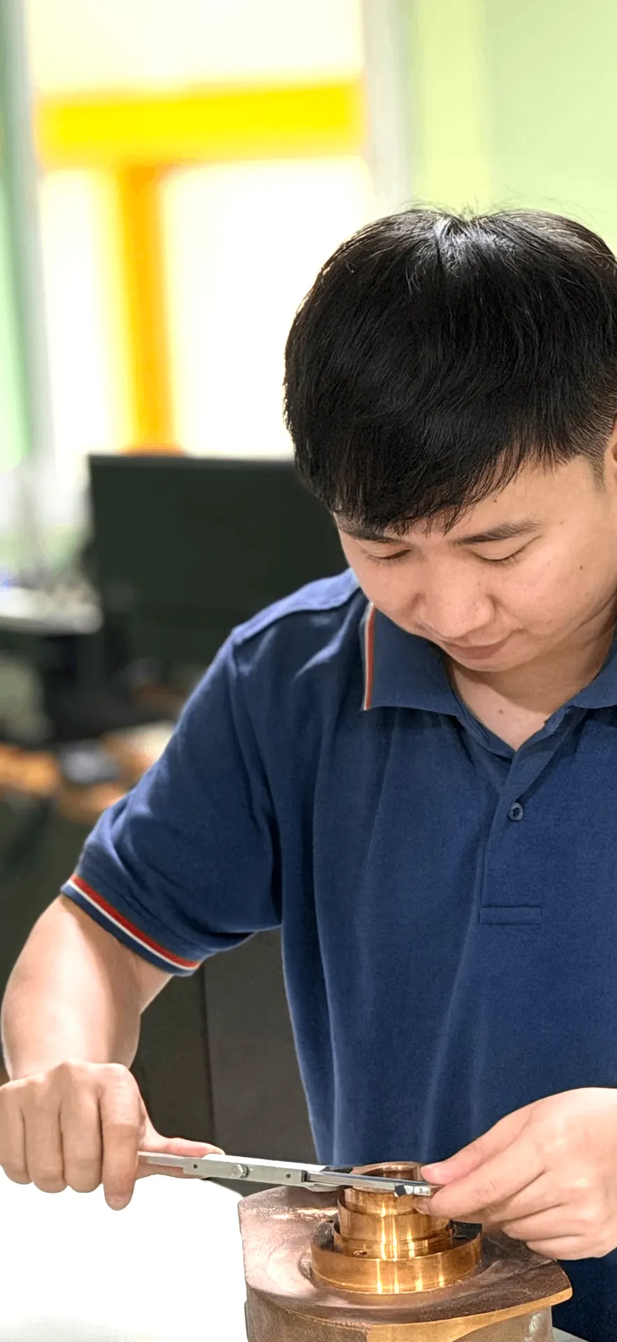 Technician measuring a manufactured component during dimensional inspection